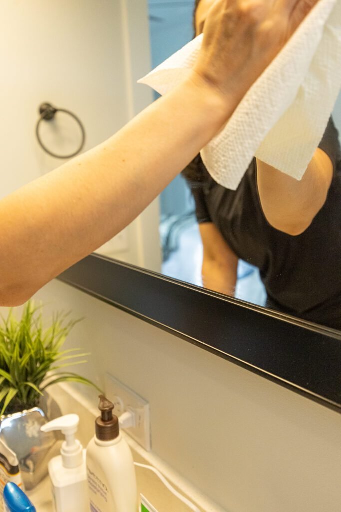 Professional cleaner wiping a kitchen surface thoroughly