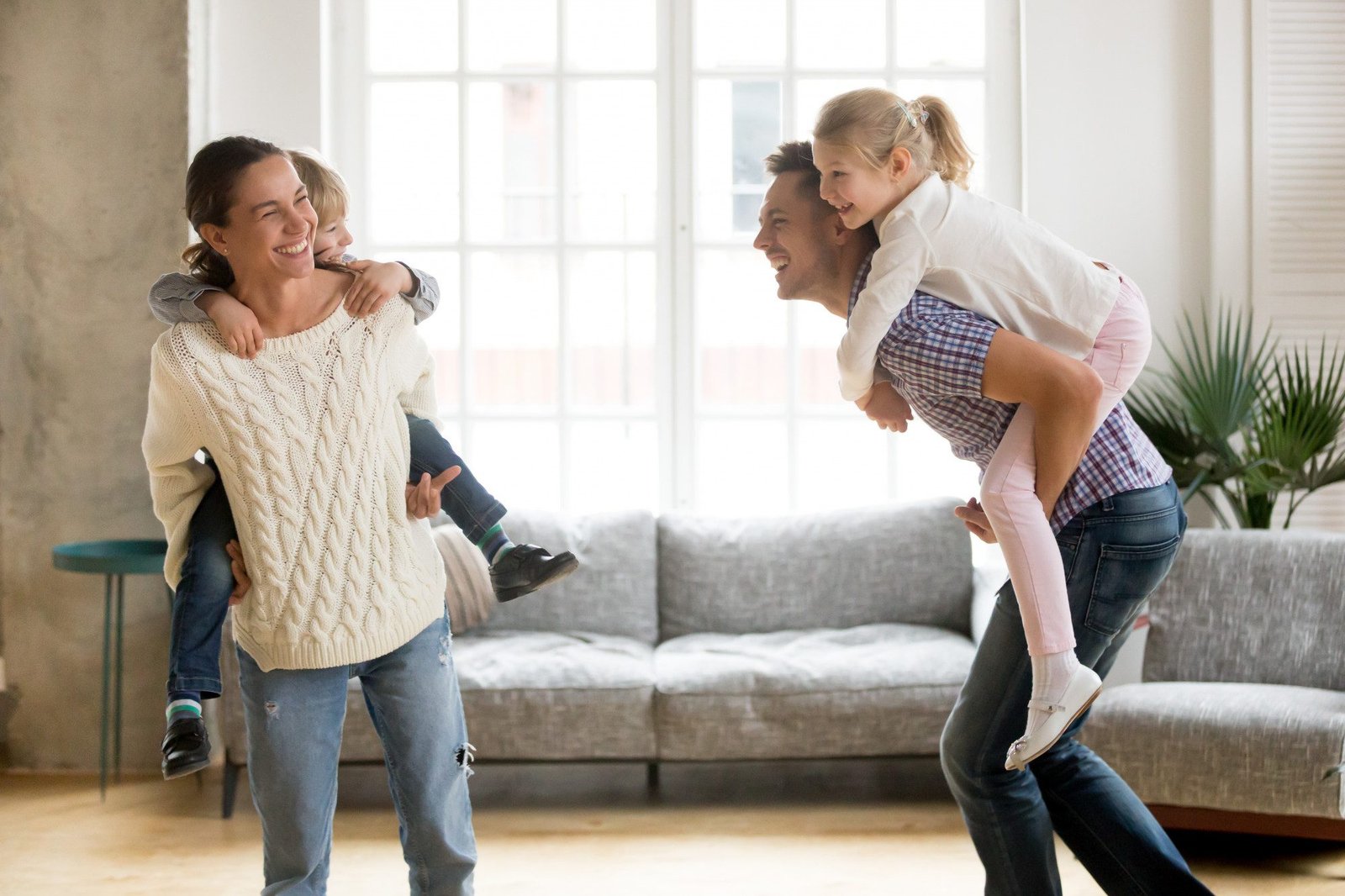 A family playing together in a bright, clean living room